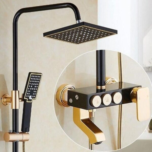 A modern black and gold shower fixture with a square overhead shower head and a handheld shower head, both featuring small perforations. The control panel includes three round buttons labeled with water temperature settings and a lever handle. The fixture is mounted on a beige tiled wall.