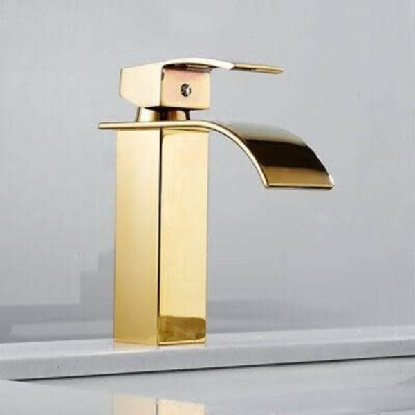 a gold kitchen tap on a white counter