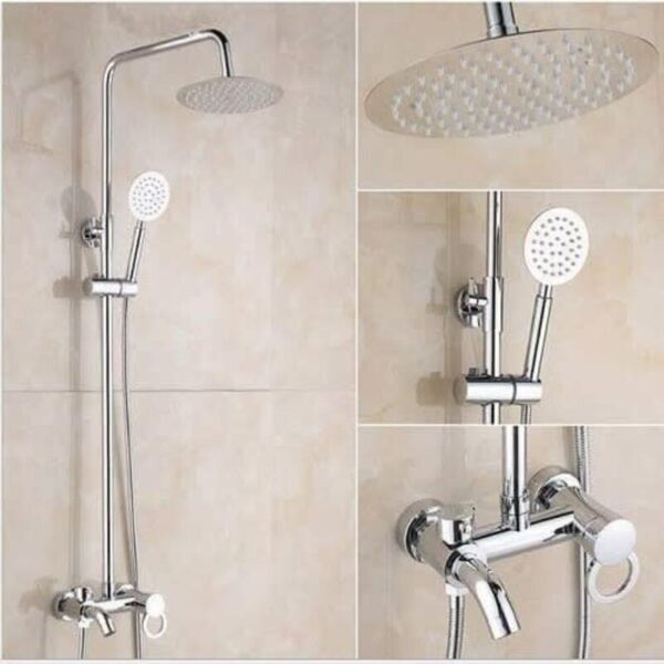 sleek chrome shower system with an overhead round shower head and a matching handheld shower head, both featuring small, evenly spaced nozzles. The system is mounted on a beige tiled wall. The overhead shower head is fixed on a curved arm extending from a vertical bar. The handheld shower head is attached to an adjustable holder on the vertical bar. The control panel at the bottom includes a cylindrical valve handle and a diverter lever. The system also features a flexible hose connecting the handheld shower head to the control panel.