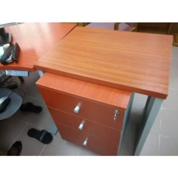 a desk with stapler and a phone on it